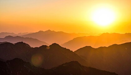 Obraz premium Golden hour illuminates layered mountain ridges under a vibrant, sun-drenched sky