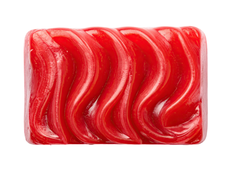 Red, rectangular candy with wavy, ridged texture on a black background