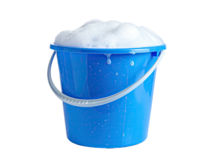 A blue plastic bucket overflowing with bubbly, white soap suds against black background