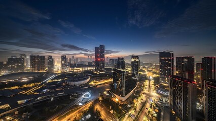 Aerial twilight view of illuminated Hangzhou cityscape with modern skyscrapers and dramatic traffic trails