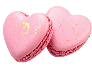 Two pink heart-shaped sweets, lightly adorned with gold flakes, on a white background