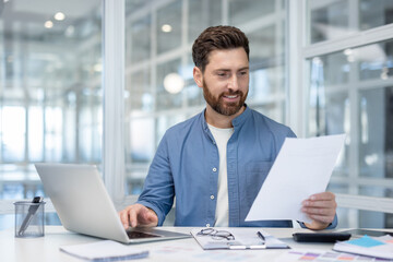 Professional man working at office desk reviewing document
