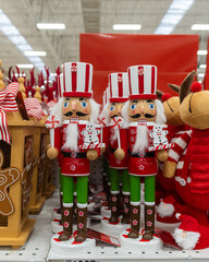 A colorful display of Christmas nutcracker ornaments at a retail store