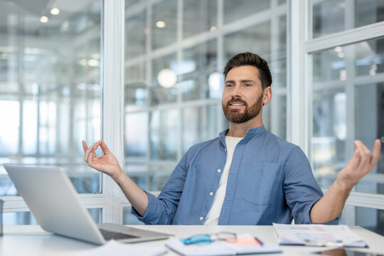 Businessman meditating during work, finding inner balance