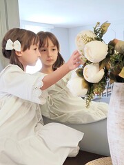 reflection of the little girl in the miror in the white dress