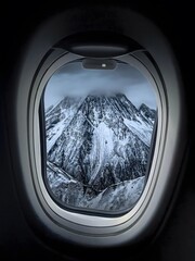 Obraz premium Snow-Covered Alpine Mountain Peaks View Through Commercial Aircraft Window During Flight