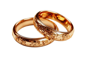 Two gold wedding bands, ornate with detailed carvings, rest atop one another