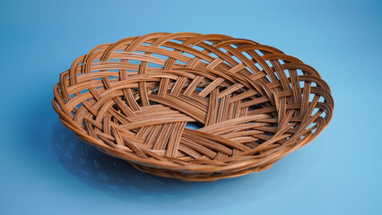 Empty Woven Rattan Basket on Blue Background