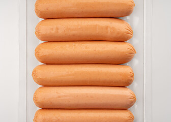 Fresh raw sausages on a white background. Meat products. Sausage. Semi-finished products.