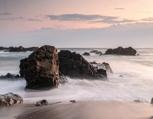 Rocky shoreline scene with water motion blurring. Cloudy sky over the ocean horizon