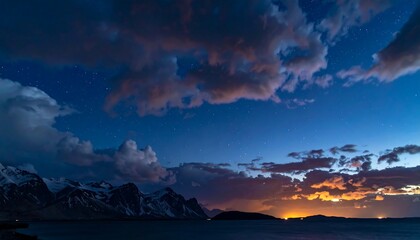 Night sky over mountains and water