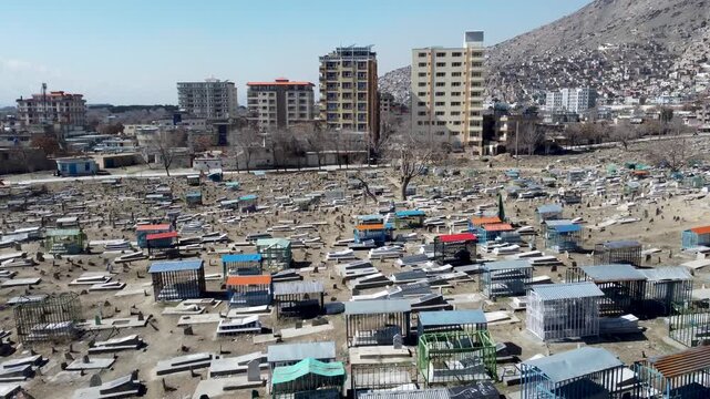 Kabul, Afghanistan. Drone Shot of Cemetery at Sakhi Shrine Mosque, Graves, Neighborhood Buildings, American war memorial