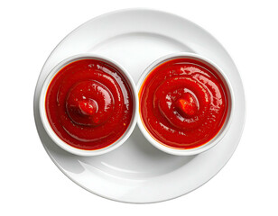 Two small bowls of a red condiment sit on a white plate, close up