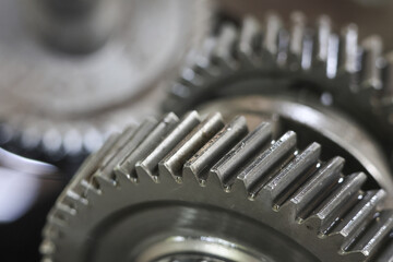 Close up of interlocking metal gears showing complex mechanical system conveying precision and...
