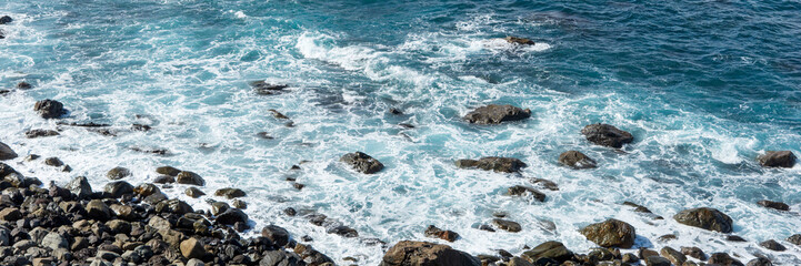Panoramic image. Waves on the rocky coast