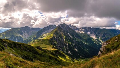 Dramatic Mountain Range Under Cloudy Sky in Daylight Green and Brown Slopes Jagged Peaks Intense Lighting and Panoramic Vista Majestic Landscape
