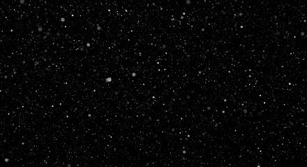 Falling particles against black background creating a sense of depth and motion