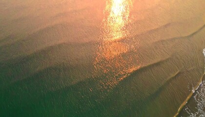 Golden sunset over ocean waves