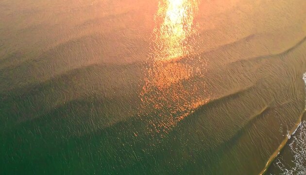 Golden sunset over ocean waves