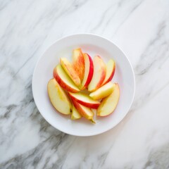 Enjoying fresh apple slices on a white plate against a textured marble background