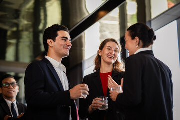 Business professionals networking at an after-work party, sharing ideas and enjoying a relaxed environment that blends business discussions with corporate culture.