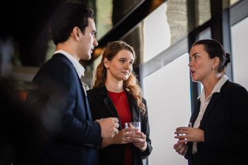 Corporate employees sharing insights at a casual networking party, symbolizing teamwork, organizational culture, and professional growth outside the office.
