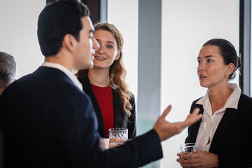 Group of executives enjoying after-work networking, reflecting the balance of business collaboration and fun social interaction.