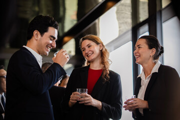 Business professionals combining work discussions or chitchat with leisure at a casual networking event, showcasing teamwork and relationship building.