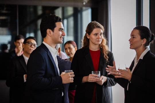 Corporate professionals connecting at an evening event, symbolizing teamwork, career growth, and organizational culture. Business partner or co-worker relaxed at after work party.