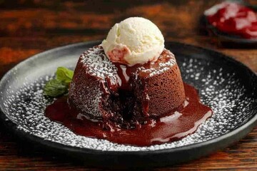 Indulgent Chocolate Lava Cake with Gooey Center Served with Creamy Vanilla Ice Cream on a Plate
