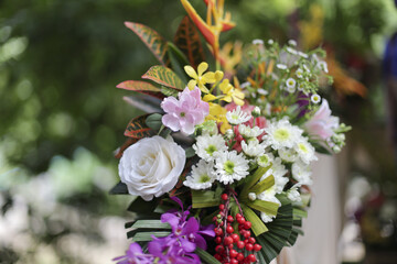 Vibrant floral arrangement bursting with diverse blossoms and foliage, evoking sense of natural beauty and celebratory joy