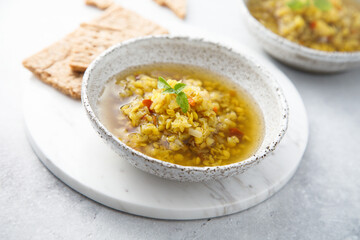 Homemade lentil soup served with basil