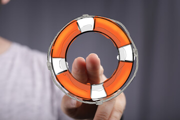 Hand reaching for a digital life preserver.  Support, rescue, safety, help concept.