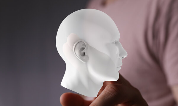 Digital human head model held in hand. AI, technology, future, innovation concept.