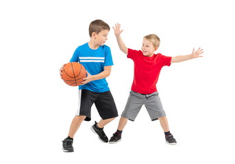 Two Young Boys Playing Basketball: Dribbling and Defending in Action