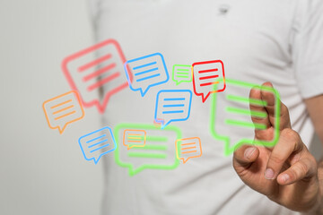 Conceptual online communication, man interacting with digital message bubbles. Digital connection and conversation.