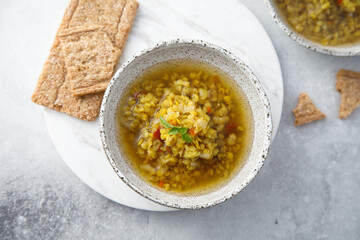 Homemade lentil soup served with basil