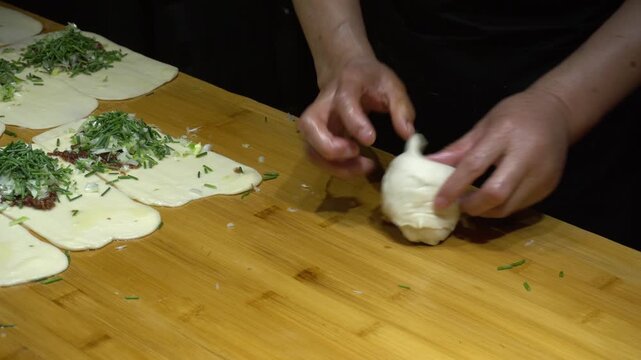 Closeup of making fried scallion beef pancakes, Dunhuang, Gansu province, China.