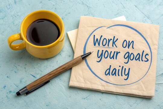 Coffee pen and inspirational note on a textured workspace
