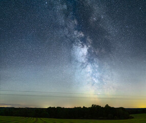Night sky full of stars. Milky Way above the telegraph poles.