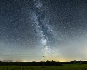 Night sky full of stars. Milky Way above the telegraph poles.