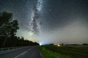 Night sky full of stars. Milky Way above the highway.
