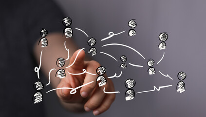 A hand interacts with a digital network display, showing interconnected people. Ideal for concepts of social media, teamwork, global communicati