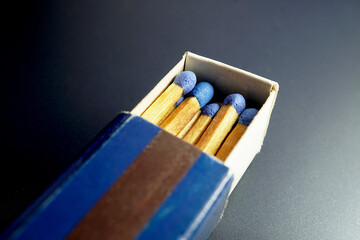 Wooden matches blue heads in box with side striking strip