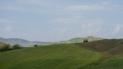 Obraz premium Eco-friendly tractor on lush green hills in rural Turkey