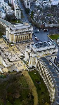 Stunning vertical video aerial of Paris Trocad&eacute;ro's Palais de Chaillot with geometric plaza patterns, Passy Cemetery. 4K drone footage shows neoclassical wings, urban landscape. Perfect mobile content