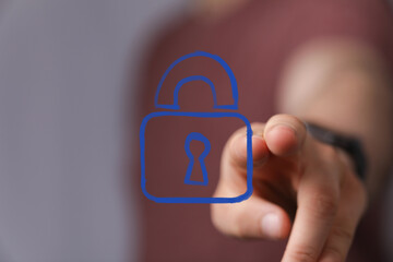 Hand interacting with a digital padlock icon, symbolizing cybersecurity, data protection, and...