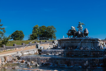 Obraz premium Copenhagen, Denmark 07-20-2025 The Gefion fountain is a large-scale group of bronze oxen pulling a plow and being driven by the Norse goddess Gefjon and located on the harbour front in Copenhagen