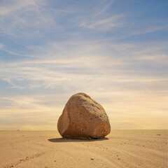 Isolated Desert Boulder Under a Dramatic Sunset Sky