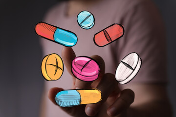 Hand interacting with colorful drawn pills and capsules. Healthcare, medicine, pharmacy concept.